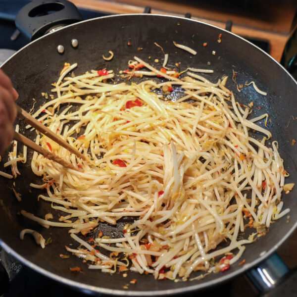 Chop sticks stirring noodles