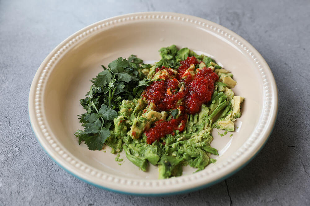 TIGER LILY PEPPER® & LIME SAMBAL GUACAMOLE mixed with avocado