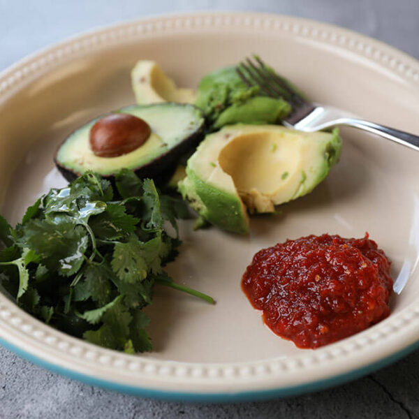 TIGER LILY PEPPER® & LIME SAMBAL GUACAMOLE with avocado on a plate